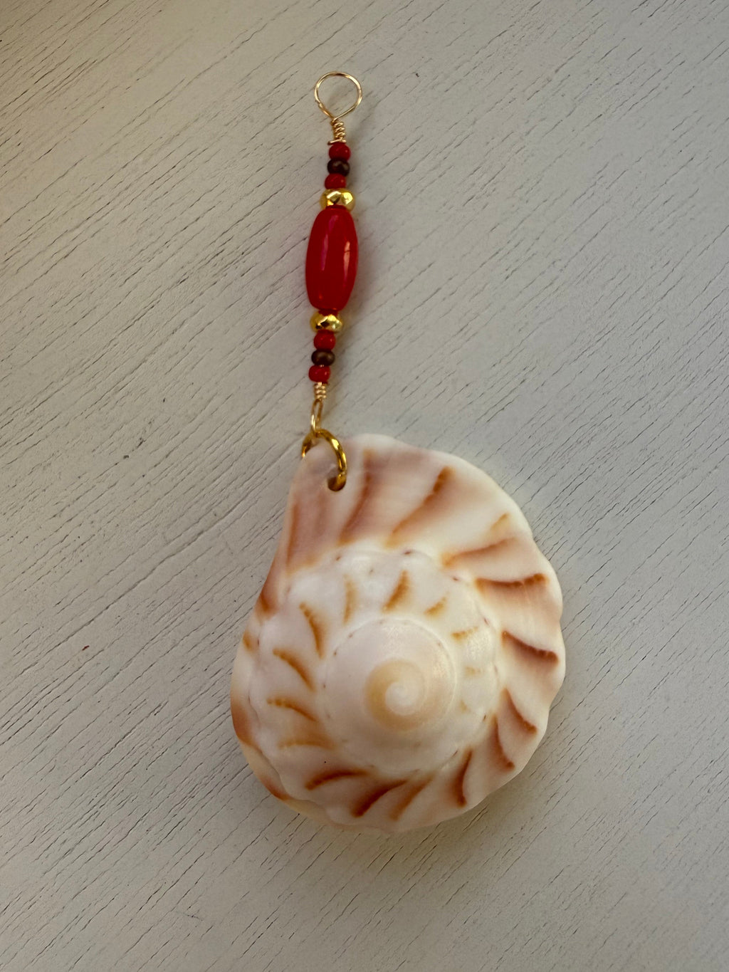 Lightning Whelk dangle earrings and drop pendant.