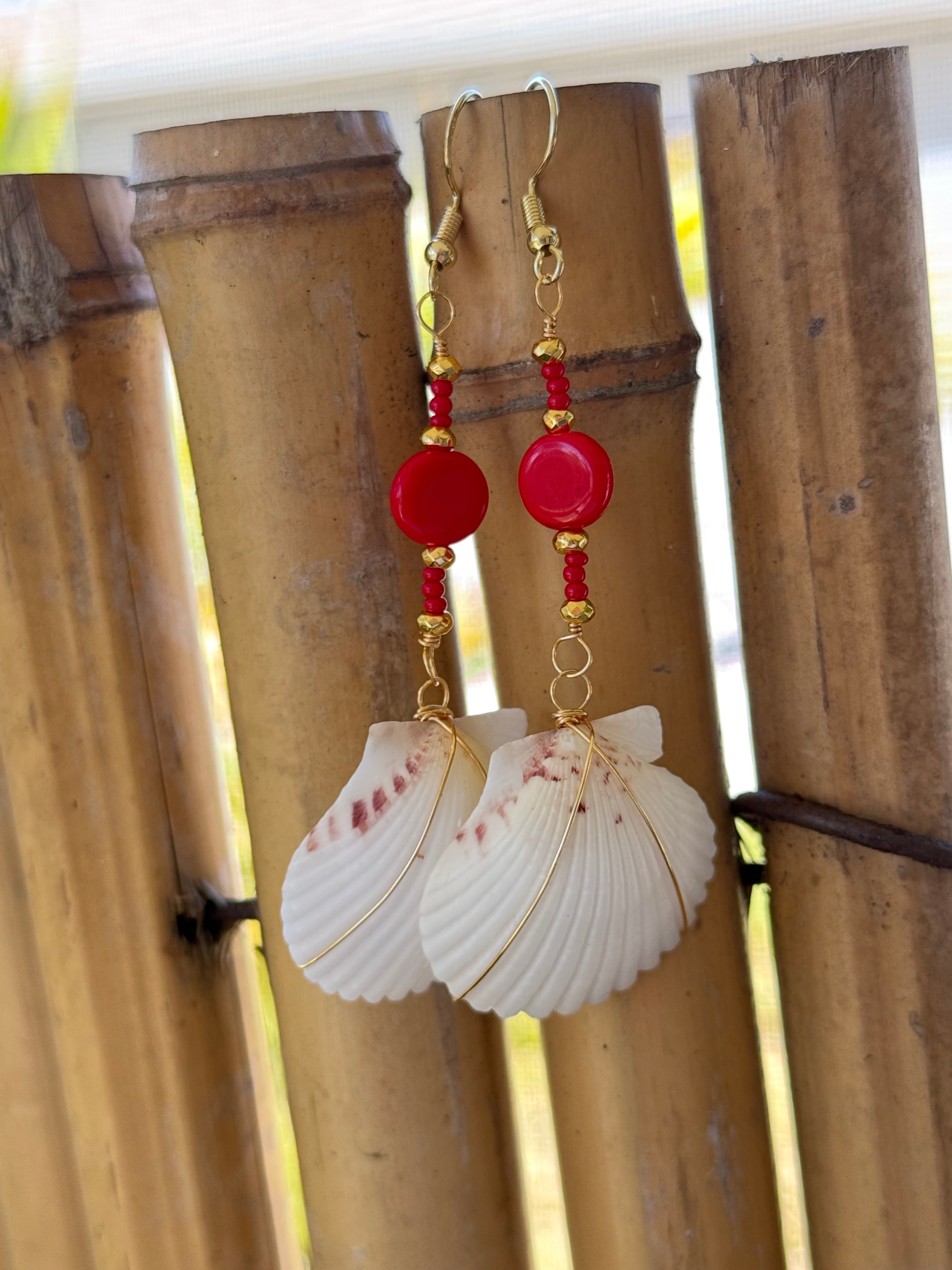 White scallop earrings with gold wire wrap, red and gold beads.