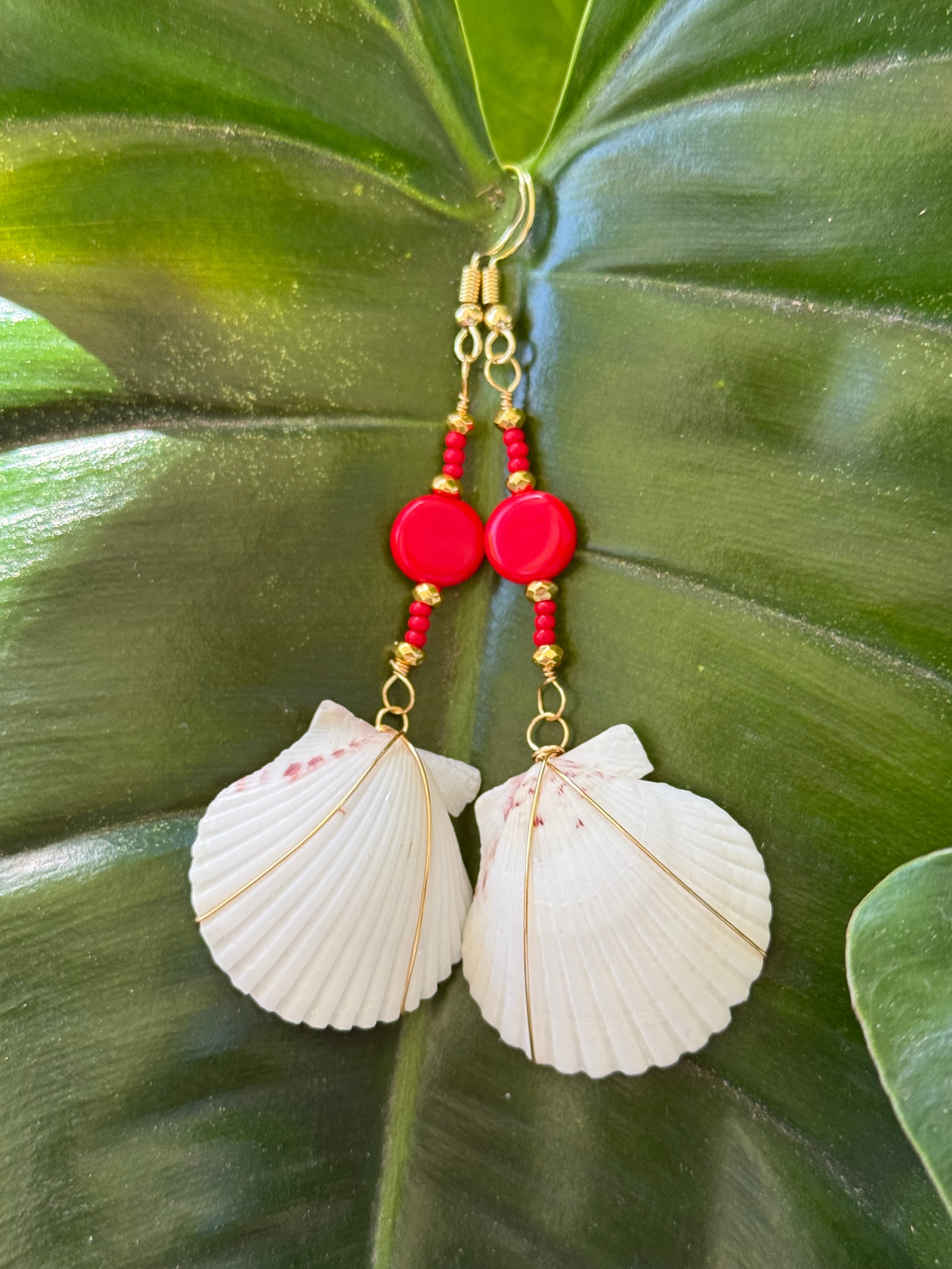 White scallop earrings with gold wire wrap, red and gold beads.
